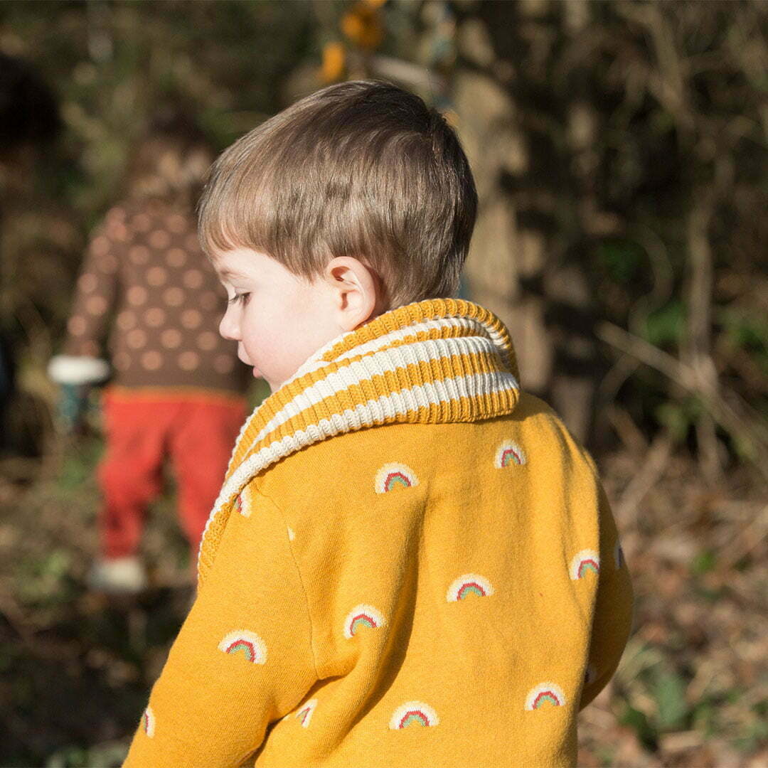 Boy wearing the yellow striped knitted scarf from little green radicals